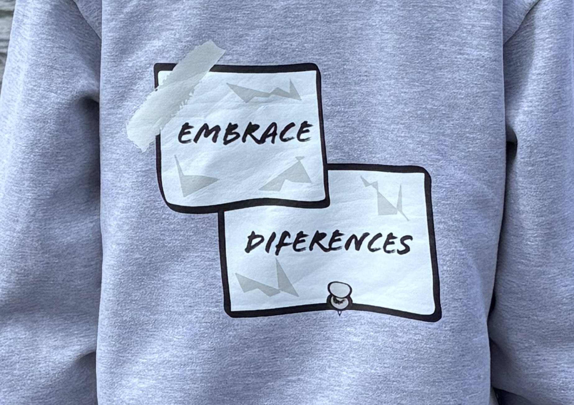 Close-up of the actual rear Embrace Diferences print on the overhead hoodie