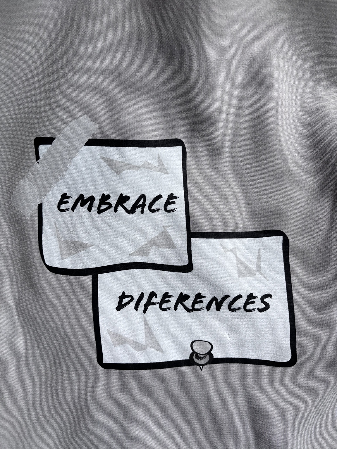 Close-up of the actual rear Embrace Diferences print on the zip hoodie