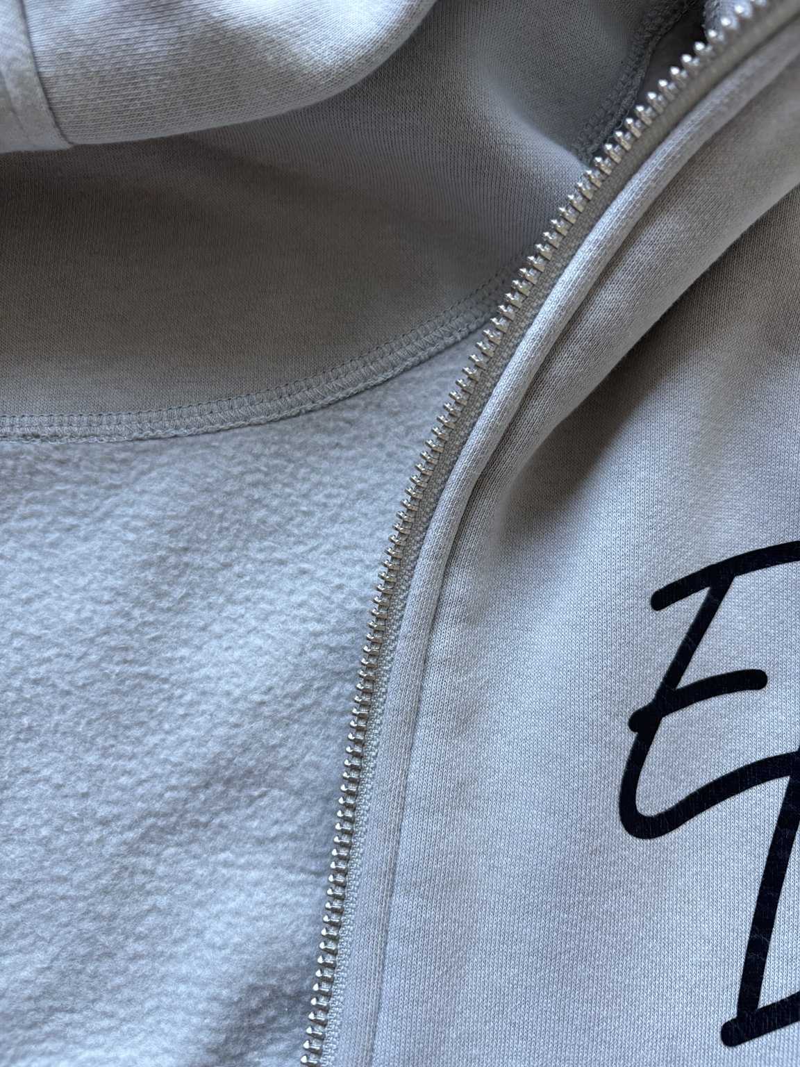 Close-up of the zip, stitching and soft inner fleece on the zip hoodie
